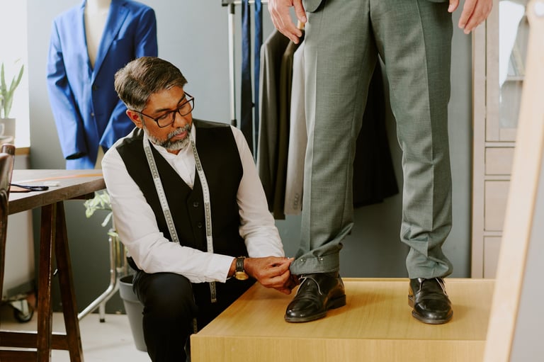 Professional tailor doing dart with pins