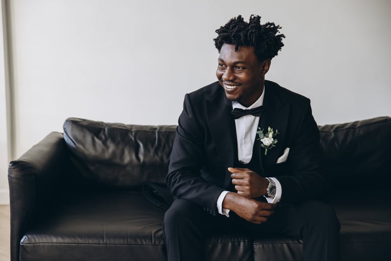 Groom in black suit with boutonniere